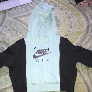 A light blue and black Nike cropped hoodie